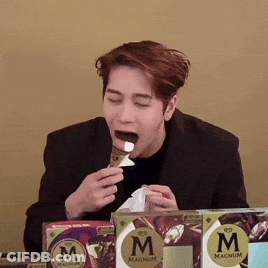 Man In Black Suit Eating Magnum Ice Cream GIF