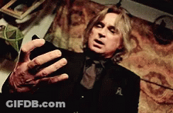 Man In Black Suit Holding Cell Phone GIF