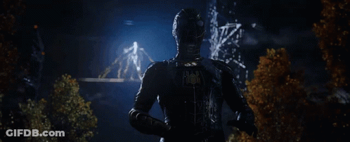 Man In Black Suit Holding Glowing Object GIF