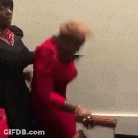 Man In Black Suit Holding Woman In Red Dress GIF