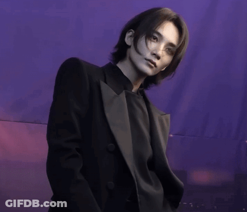 Man In Black Suit In Purple Background GIF