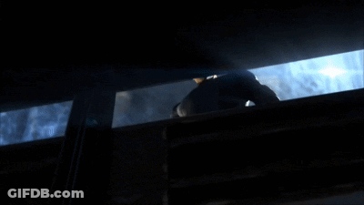 Man In Black Suit Looking Out Window GIF