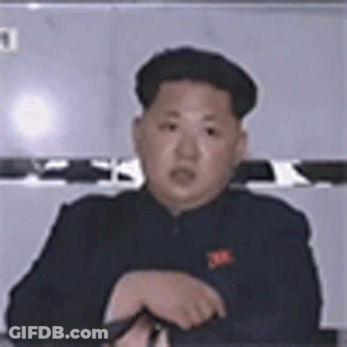 Man In Black Suit Sitting At Table GIF