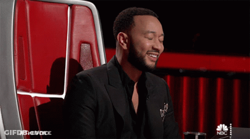 Man In Black Suit Sitting In Red Chair Eyes Closed GIF
