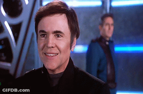 Man In Black Suit Smiling In Front Of Man In Blue Suit GIF