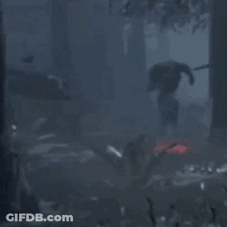Man In Black Suit Standing In Dark Forest GIF