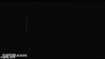 Man In Black Suit Standing In Dark Room GIF