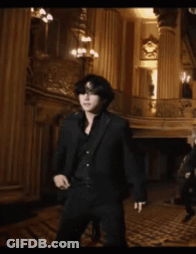 Man In Black Suit Standing On Balcony GIF