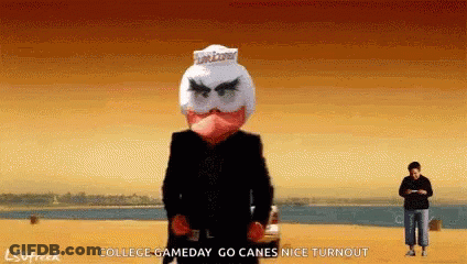 Man In Black Suit Standing On Beach GIF