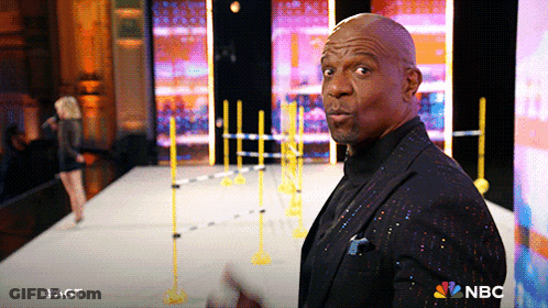 Man In Black Suit Standing On Stage With NBC Logo GIF