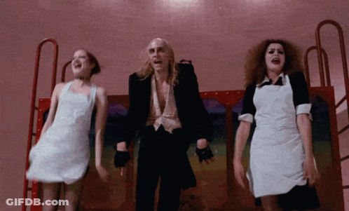 Man In Black Suit Surrounded By Two Women GIF