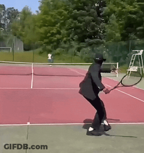Man In Black Suit Swinging Tennis Racquet GIF
