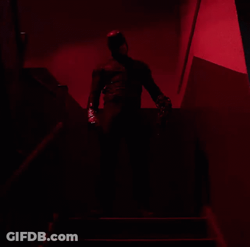 Man In Black Suit Walking Down Stairs GIF
