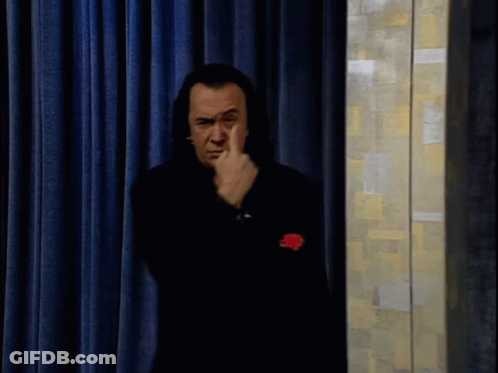 Man In Black Suit Waving Hand GIF