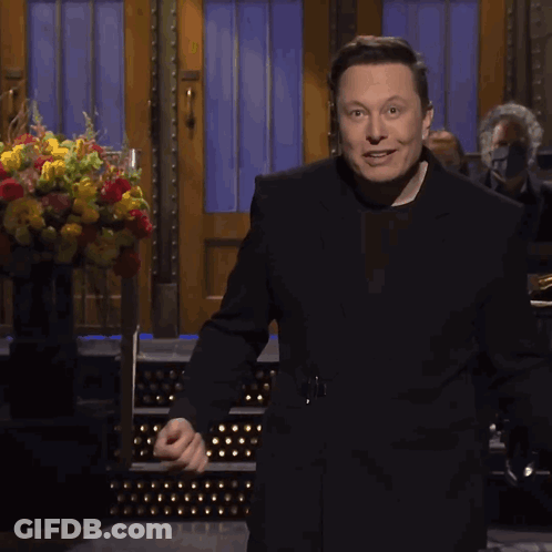 Man In Black Suit With Flowers GIF