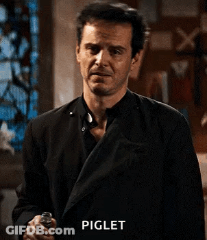 Man In Black Suit With Hands On Chest GIF