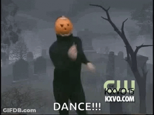Man In Black Suit With Pumpkin Head Dancing In Cemetery GIF
