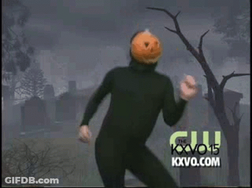 Man In Black Suit With Pumpkin Head Dancing In Cemetery GIF