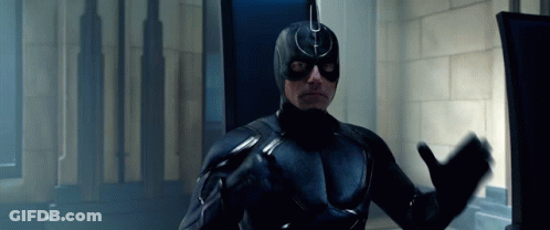 Man In Black Superhero Costume At Computer GIF