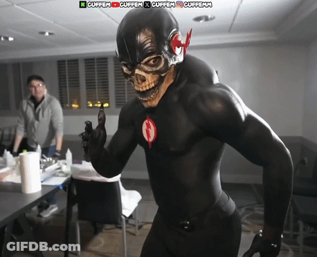 Man In Black Superhero Costume Standing Before Cuffen Sign GIF