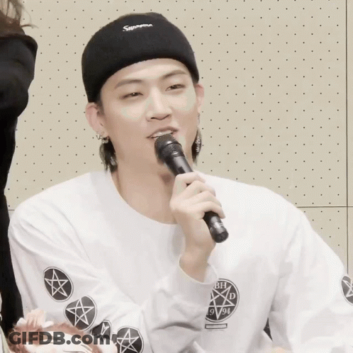 Man In Black Supreme Headband Holding Microphone GIF