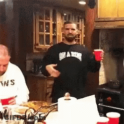 Man In Black Swans Shirt Holding Red Cup GIF