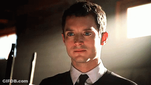 Man In Black Sweater And Tie Holding Knife GIF