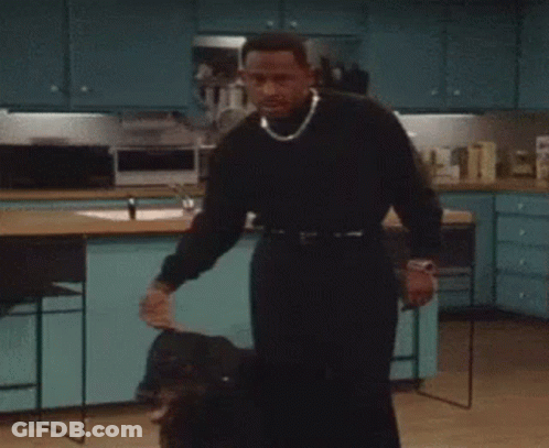 Man In Black Sweater Holding Dog GIF