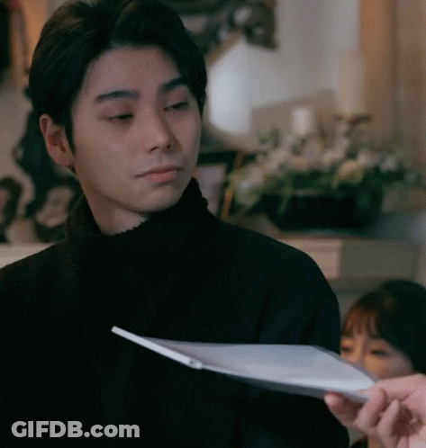 Man In Black Sweater Looking At Paper GIF