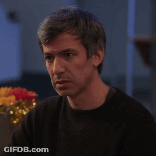 Man In Black Sweater Looking At Something GIF