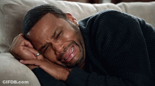Man In Black Sweater Lying Crying GIF