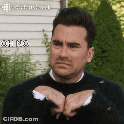Man In Black Sweater Making Funny Face Holding Hands Together GIF