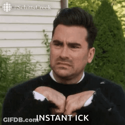 Man In Black Sweater Making Funny Face Saying Instant Ick GIF