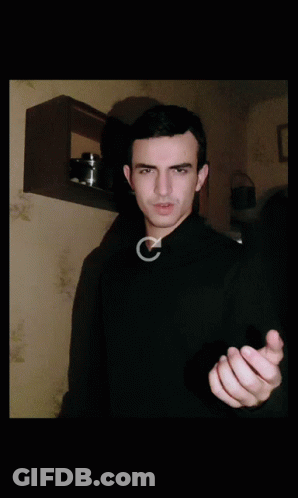 Man In Black Sweater Making Gesture GIF