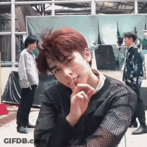 Man In Black Sweater Shushing Another Man GIF