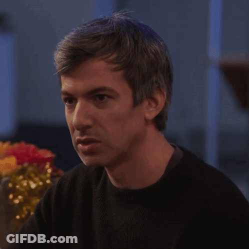 Man In Black Sweater Sitting At Table GIF