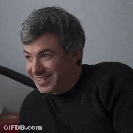 Man In Black Sweater Smiling At Camera GIF