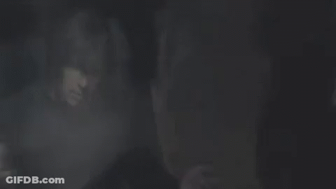 Man In Black Sweater Standing Before Crowd GIF