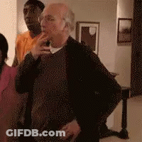 Man In Black Sweater Standing With Group GIF