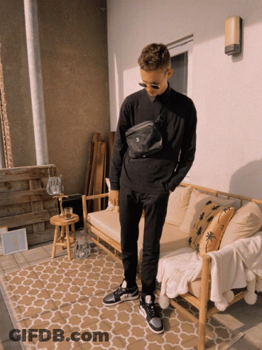 Man In Black Sweatshirt And Pants By Wooden Couch GIF