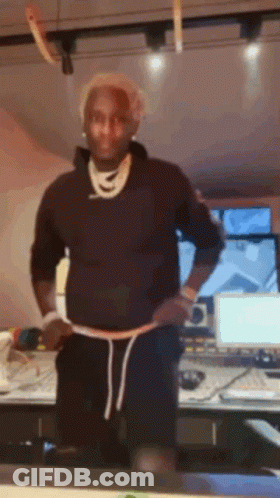 Man In Black Sweatshirt And Shorts Before Computer Monitor GIF