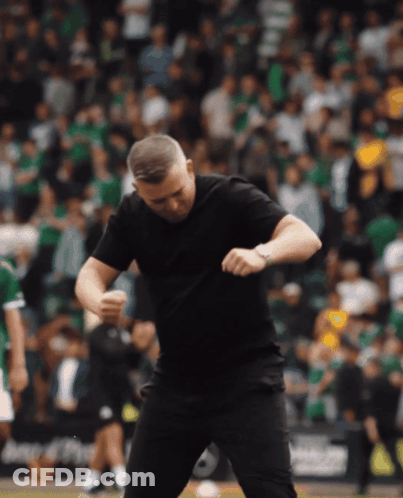 Man In Black T-Shirt Dancing In Front Of Crowd GIF