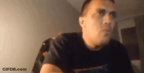 Man In Black T-Shirt Sitting At Table GIF