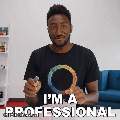 Man In Black T-Shirt With Rainbow Circle Says I'm A Professional GIF