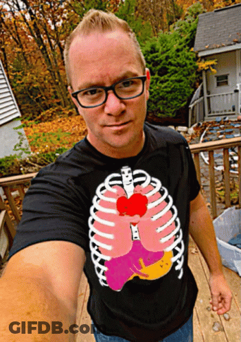 Man In Black T-Shirt With Skeleton Ribs And Heart GIF