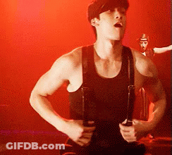 Man In Black Tank Top And Suspenders Holding Guitar GIF