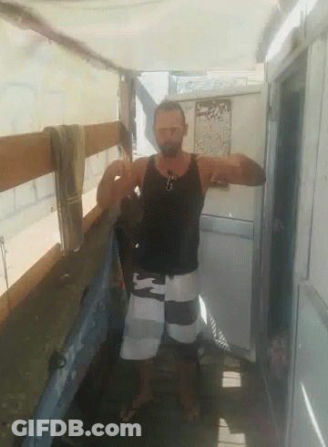 Man In Black Tank Top And White Shorts In Front Of Door GIF