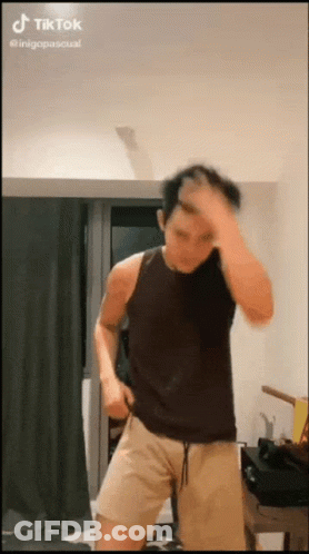 Man In Black Tank Top Dancing In Living Room GIF
