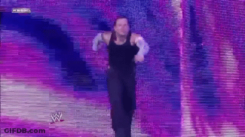 Man In Black Tank Top Dancing On Stage With W Logo GIF