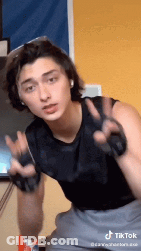 Man In Black Tank Top Giving Peace Sign GIF